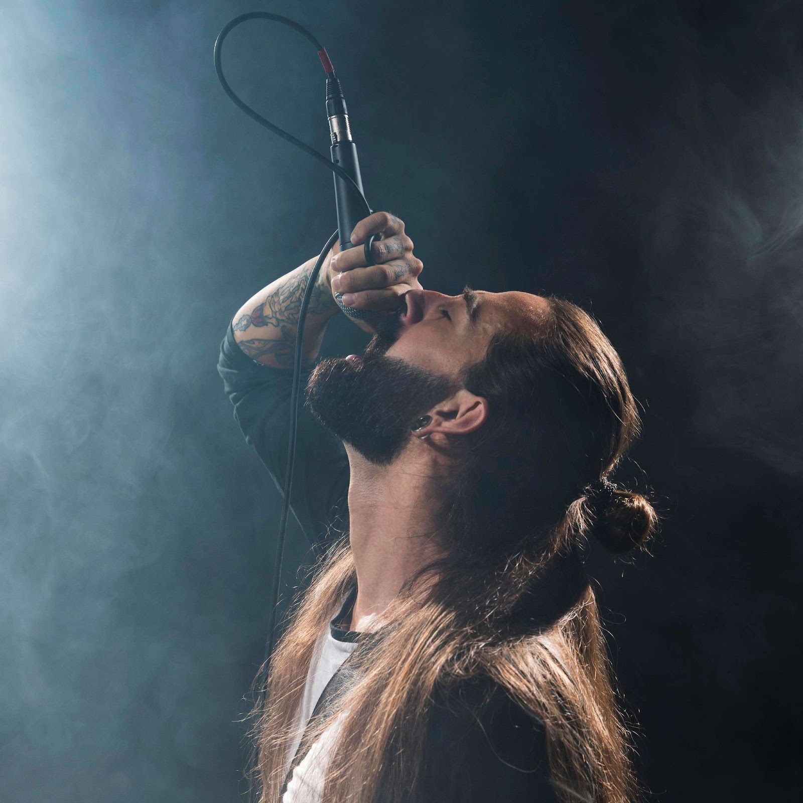 A man with long hair singing