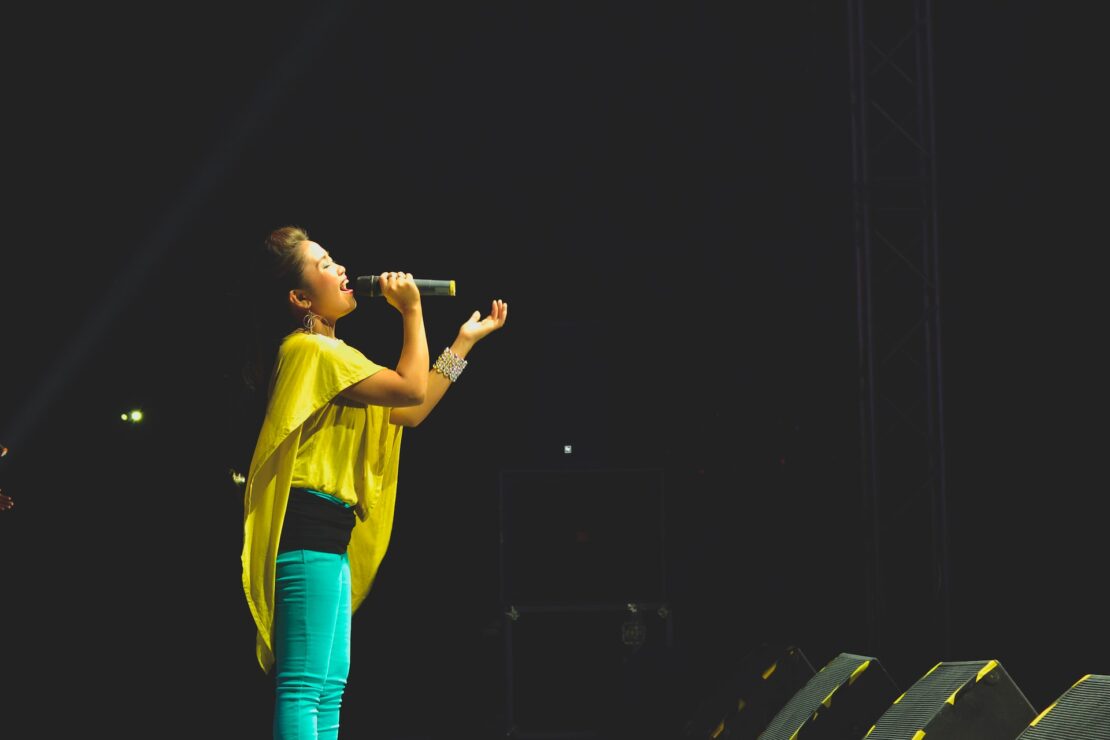 woman holding microphone and singing