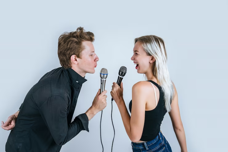 Man and Woman Holding Microphones and Singing