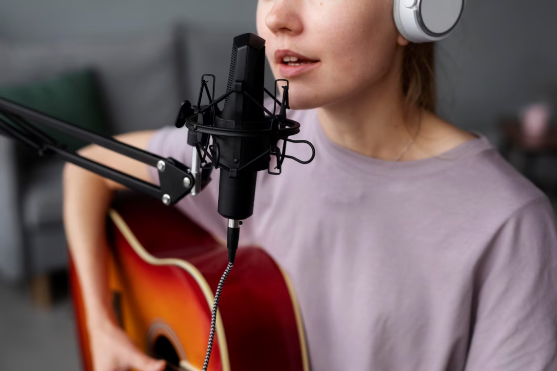 Close up woman playing the guitar and singing