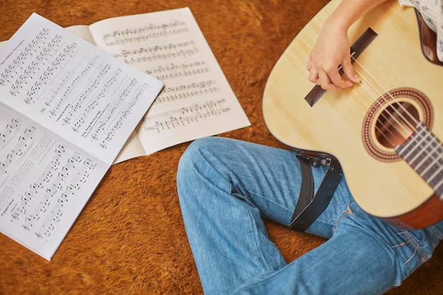 Girl learning to play guitar at home