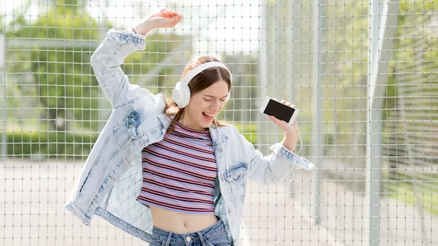 Happy woman listening to music and dancing