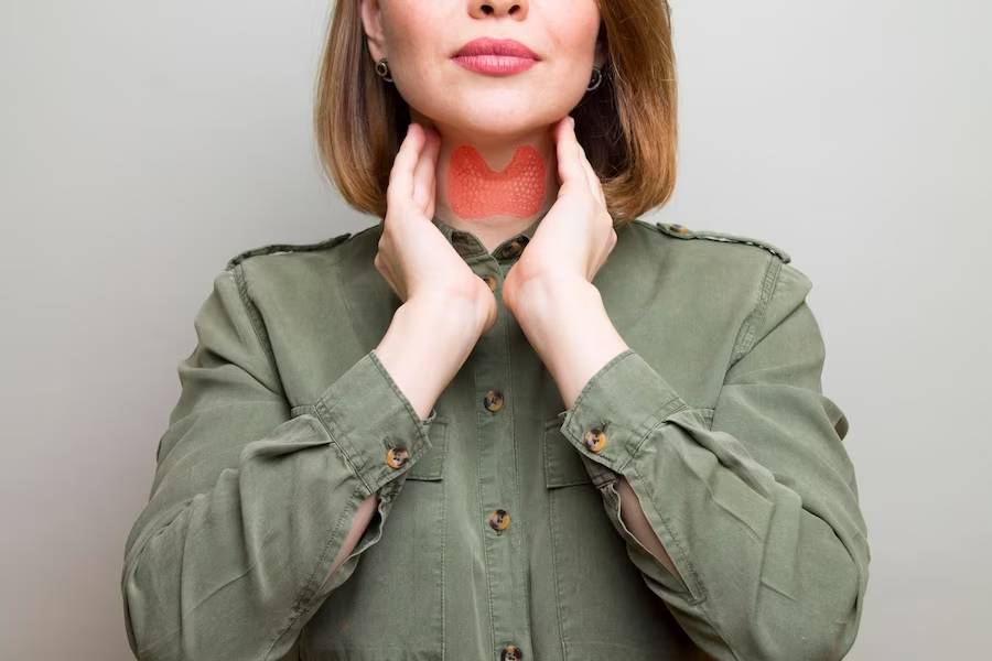 A woman holding her throat with an overlay graphic of the throat