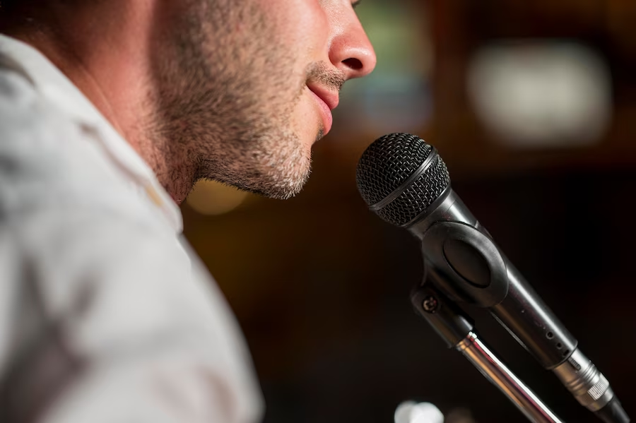 Close-up of a man's mouth with a microphone