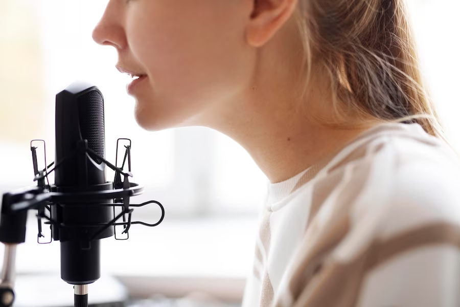 Close-up of woman singing on a microphone