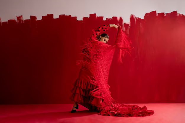 Girl in red attire dancing the flamenco on a red background