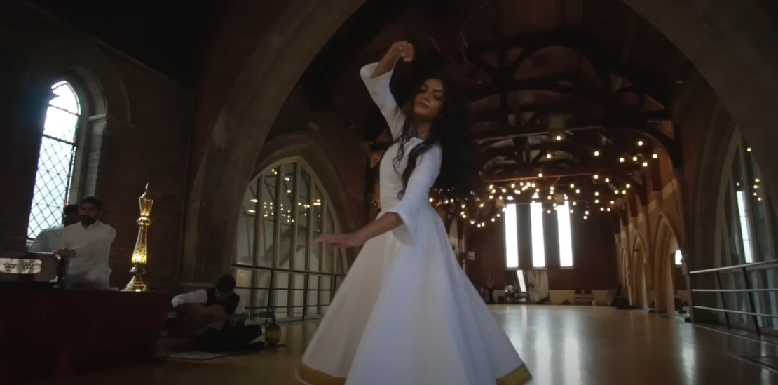 Girl in a white dress dancing to Spiritual Qawwali music